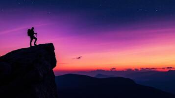 A hiker stands on a cliff at sunset, capturing a moment of adventure and serenity. photo