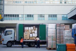 Workers loading boxes into a truck at a distribution center. photo