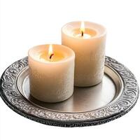 Two lit candles on a decorative silver tray, creating a warm and inviting ambiance. photo
