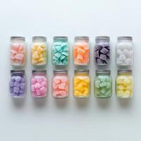 A collection of colorful jars filled with shaped candies arranged in a grid pattern. photo