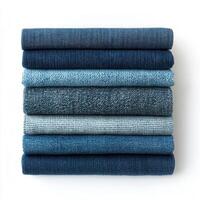 A stack of various blue fabrics arranged neatly, showcasing different textures and shades. photo
