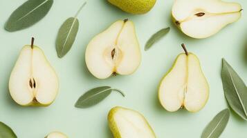 A flat lay of pear halves and sage leaves on a soft green background. photo