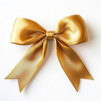 A shiny gold satin bow with long tails, commonly used for decoration or gift wrapping. photo