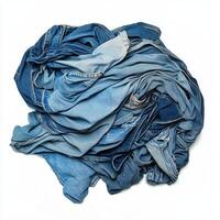 A tangled pile of various shades of denim fabric photo