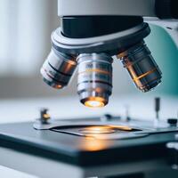 A close-up of a microscope, highlighting its lenses and stage for scientific examination. photo