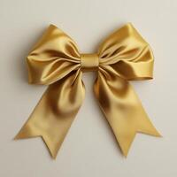 A shiny golden bow with wide loops and trailing ribbons, often used for decoration or gifts. photo