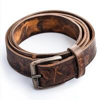 A rolled brown leather belt with a metal buckle, showcasing its texture and craftsmanship. photo