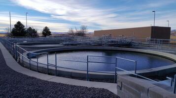 A water treatment facility featuring circular sedimentation tanks and infrastructure. photo