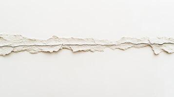 A textured, torn strip of white material against a plain background. photo