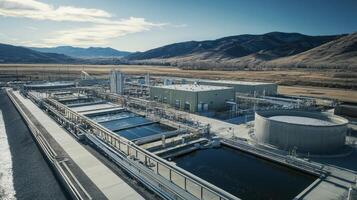 Aerial view of a water treatment facility surrounded by mountains and open land. photo