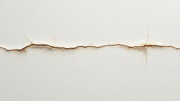 A close-up of a crack in a white wall, revealing underlying textures and colors photo