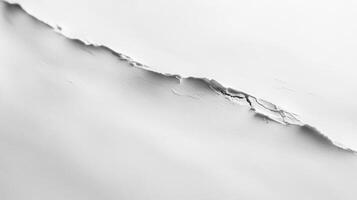 A close-up of a torn white surface, showcasing texture and depth photo