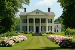 A classic house surrounded by vibrant flowers and a well-maintained lawn photo