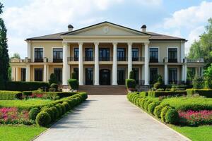 A grand mansion with columns, surrounded by manicured gardens and vibrant flowers photo