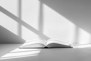 An open book on a table, illuminated by soft shadows. photo