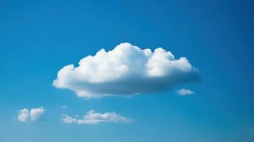 A fluffy white cloud floating in a clear blue sky. photo