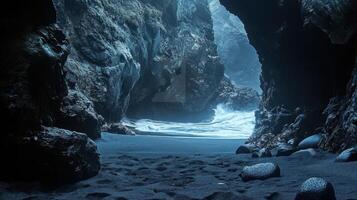 A serene coastal cave scene with waves crashing on a sandy beach, illuminated by soft light. photo