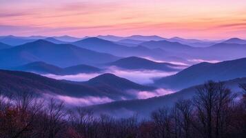 Serene mountain landscape at dawn with mist and soft pastel colors. photo