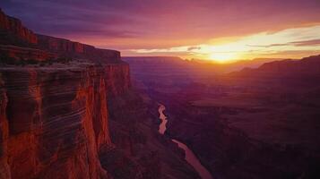 A stunning sunset over the Grand Canyon, highlighting its majestic cliffs and winding river. photo