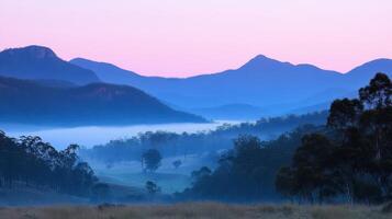 Serene landscape with misty mountains and soft pastel sky at dawn. photo