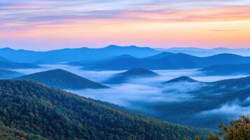 Serene mountain landscape at sunrise with mist covering the valleys. photo