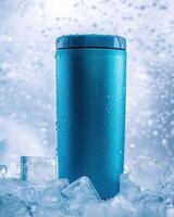 A blue insulated tumbler surrounded by ice, emphasizing cold beverage storage photo