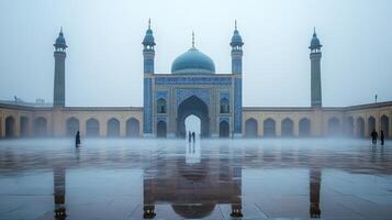A serene architectural scene featuring a grand mosque with reflections in misty surroundings. photo
