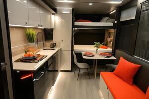 Modern interior of a compact living space with kitchen, dining area, and sleeping quarters photo