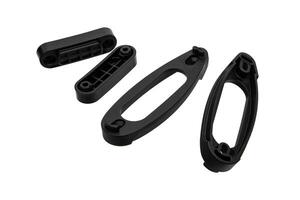 Black plastic spacers designed for extending the stock of rifles or shotguns, isolated on a white background. photo