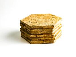 Stack of cork hot pads in hexagon shape isolated on white background photo