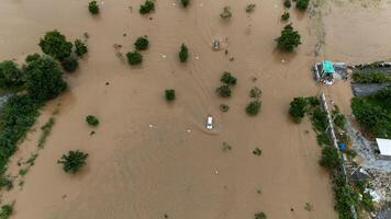 Car driving on the road flooded during typhoon Yagi has swept Chiang Rai province of Thailand. photo