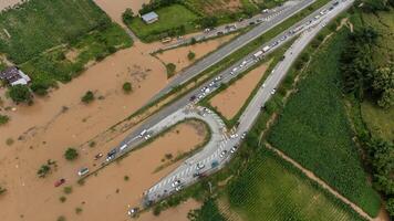 Aerial view of car driving on the road flooded during typhoon Yagi has swept Chiang Rai province of Thailand. photo