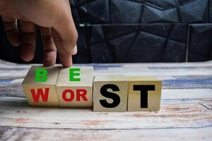 Concept word Best or worst, changes thw eord best to worst on wooden blocks on a wooden table photo