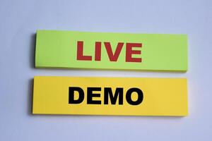 Concept of Live Demo write on sticky notes isolated on Wooden Table. photo