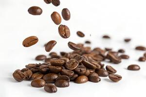 Coffee beans falling from the sky on white photo