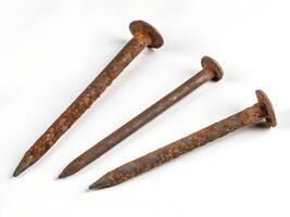 Set of Three Rusty Nails Floating on . photo