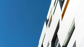 New white modern building architecture on blue sky background,Low angle architectural exterior view of modern, copy space for text photo