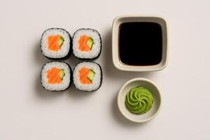 Salmon sushi rolls with cucumber served with soy sauce and wasabi on light background, traditional Japanese cuisine in minimalist style photo
