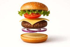 Deconstructed floating cheeseburger with sesame bun, lettuce, tomato, cheese, beef patty, and red onion on white background photo