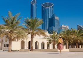 woman exploring Qasr Al Hosn Park in Abu Dhabi. Surrounded by lush greenery and historical landmarks, she enjoys the serene atmosphere and Emirati heritage in heart of Abudhabi. photo