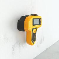 Yellow and Black Stud Finder Mounted on Wall photo