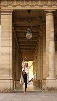 Ballet dancer posing in classical architectural colonnade photo