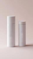 Two sleek white cylindrical containers in different sizes are placed on a soft pink background, showcasing modern design and minimalism photo