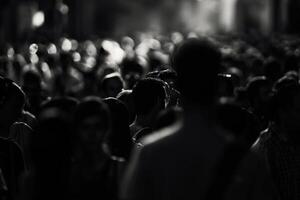 A large crowd fills the urban environment, captured in black and white, highlighting the diversity and anonymity of the people photo