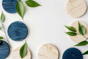 Wooden coasters in varying shades of light and navy are complemented by fresh green leaves photo
