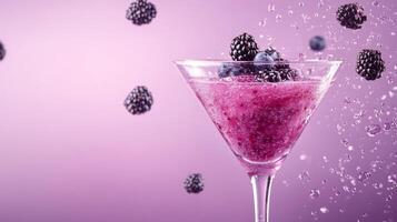 Refreshing and colorful fruit alcohol drink in a martini glass features splashes of blackberries and blueberries, set against a soft purple background photo