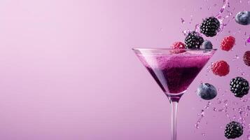A vibrant martini glass filled with a fruity cocktail, splashing berries and droplets in an artistic display on a smooth pink backdrop photo