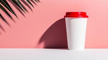 A red cup sitting on a table next to a palm tree photo