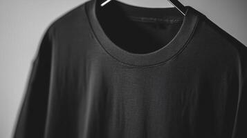 A black t - shirt hanging on a hanger photo