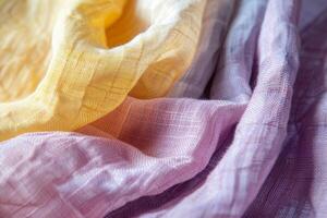 This close-up showcases the intricate textures and harmonious color palette of softly draped fabric, blending warm yellows with tranquil purples photo